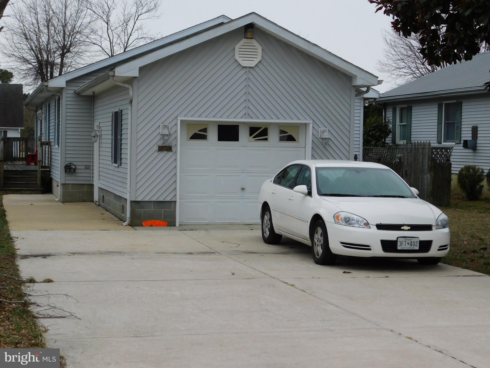 a front view of a house with parking space