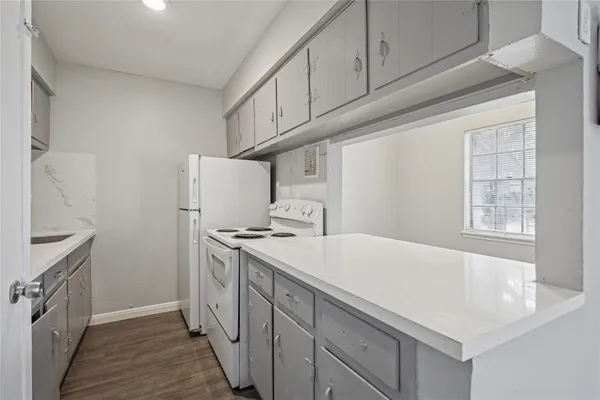 a kitchen with a stove and a white refrigerator