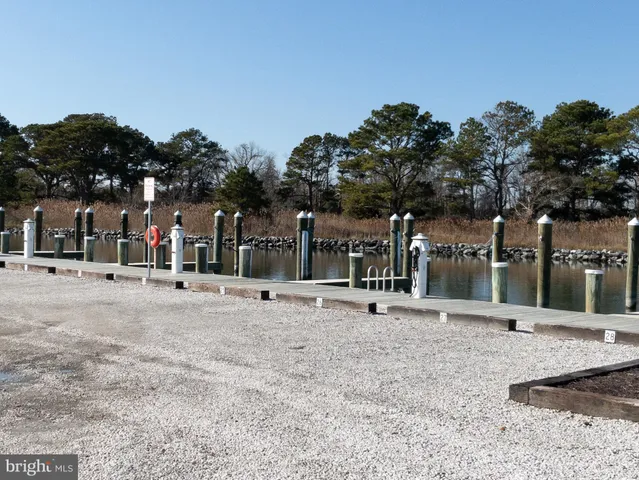 a group of people sitting in a yard in front of building