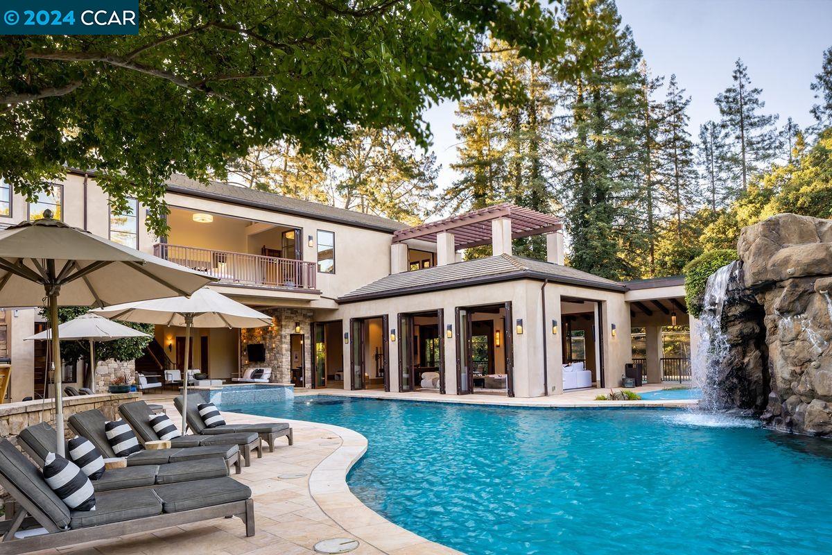 a view of a white house with a yard porch and sitting area