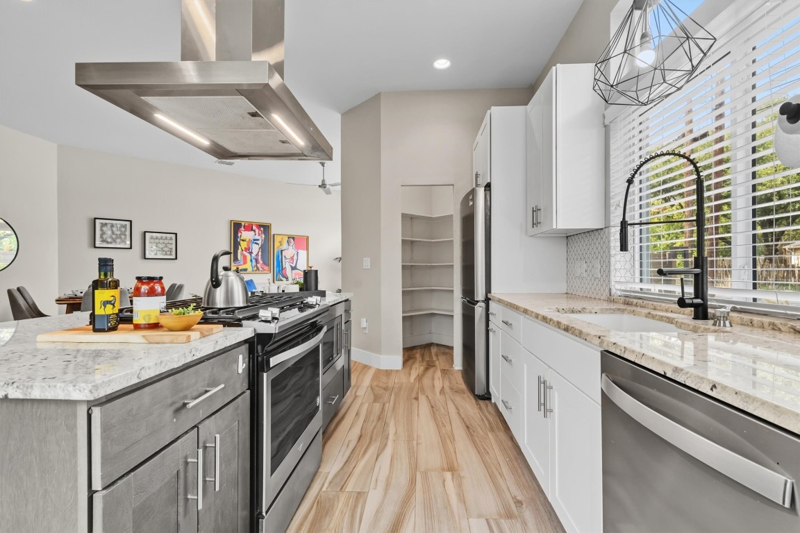 5609 Tura Lane, Unit A Austin, TX 78721 - Photo 11 of 38 Two-toned cabinetry adds a charming touch to the design.