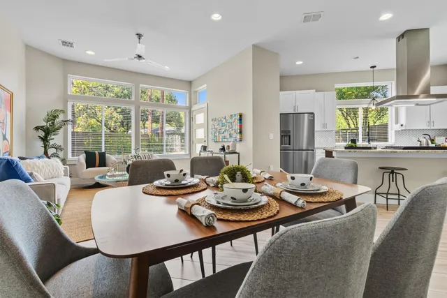 a view of a dining room with furniture large windows and wooden floor