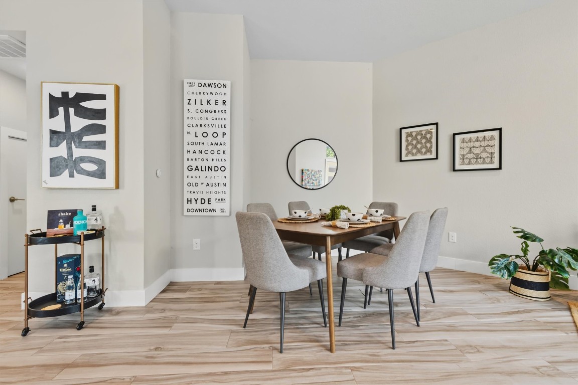 5609 Tura Lane, Unit A Austin, TX 78721 - Photo 18 of 38 a view of a dining room with furniture and wooden floor