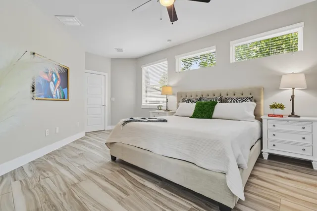 a bedroom with a bed and painting on the wall