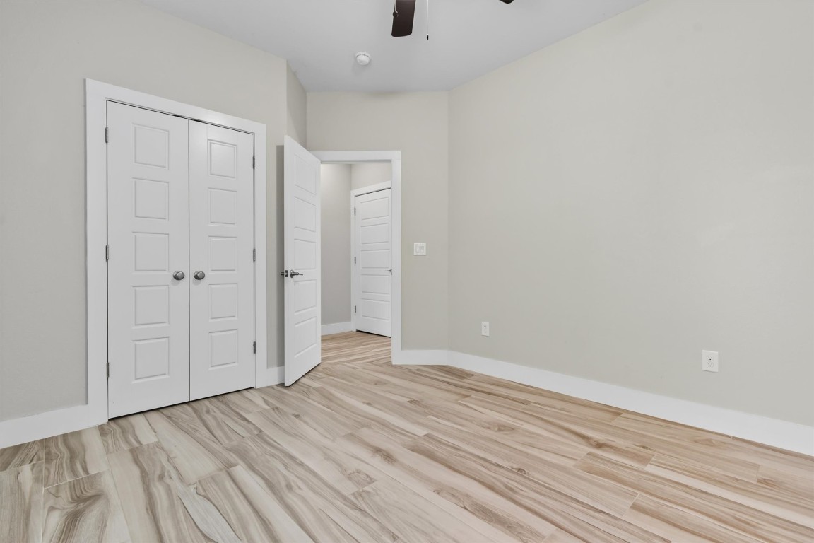 5609 Tura Lane, Unit A Austin, TX 78721 - Photo 29 of 38 a view of an empty room with wooden floor