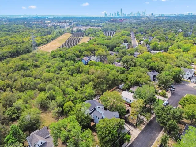 an aerial view of a houses with a yard