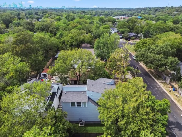 an aerial view of a house with a yard
