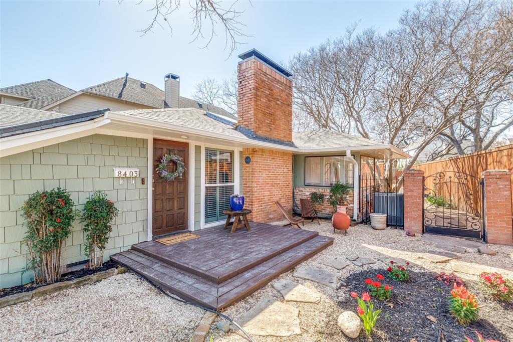 Front of property featuring privacy fence, newly installed roof, and wrought iron gate to backyard oasis