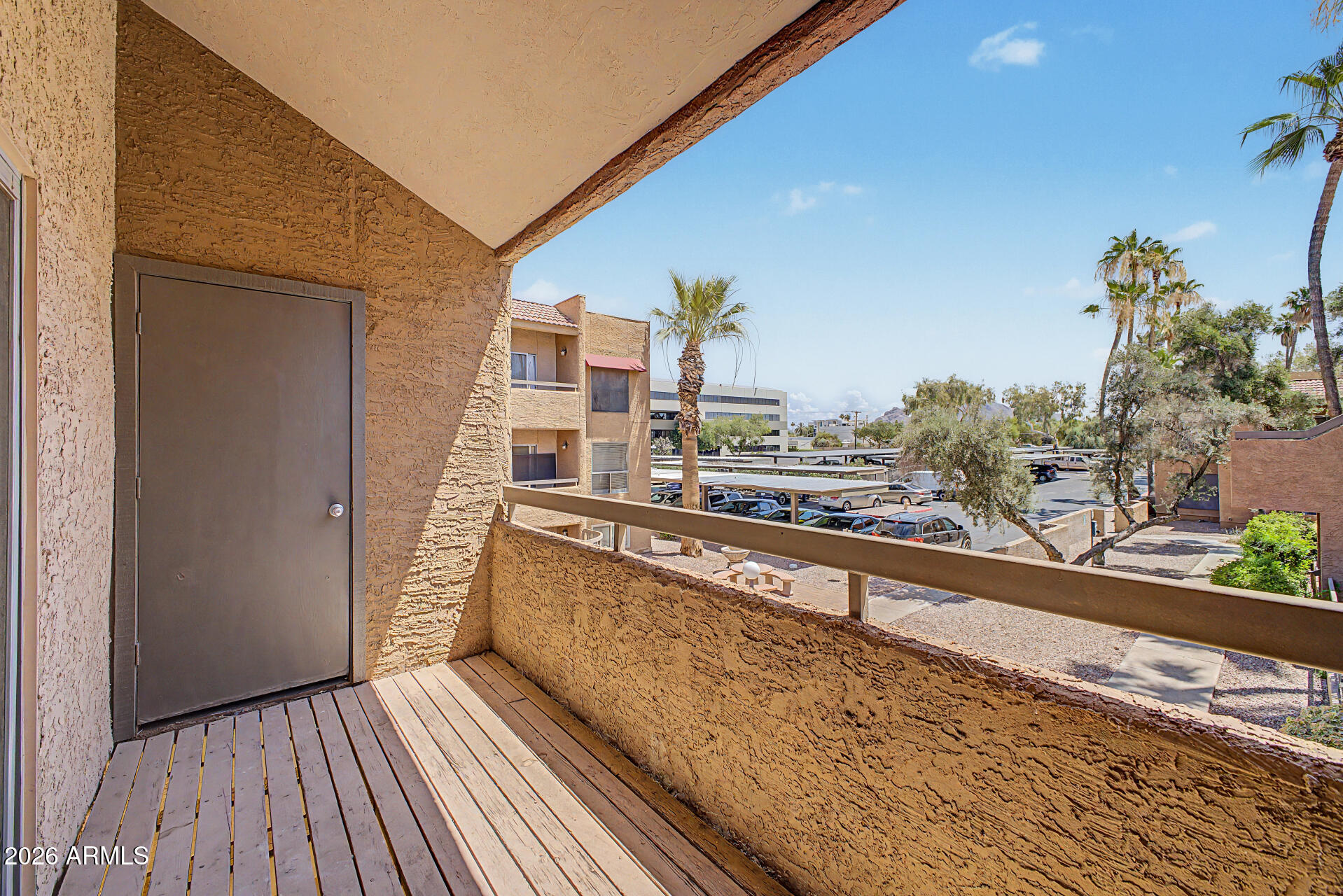 2625 East Indian School Road, Unit 227 Phoenix, AZ 85016 - Photo 20 of 31 a view of a balcony with wooden floor and plants