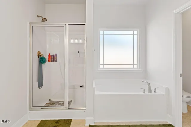 a view of walk in closet with clothes