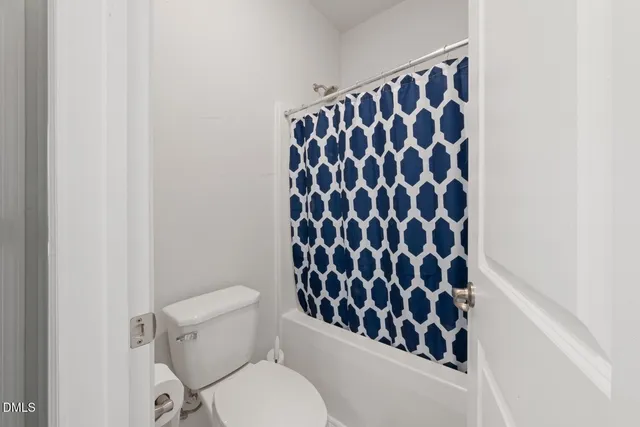 a view of a livingroom with workspace and a window