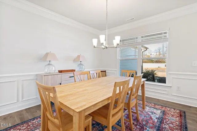 a kitchen with stainless steel appliances granite countertop a sink a stove and a wooden floors