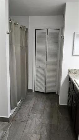 a bathroom with a bath tub with a shower