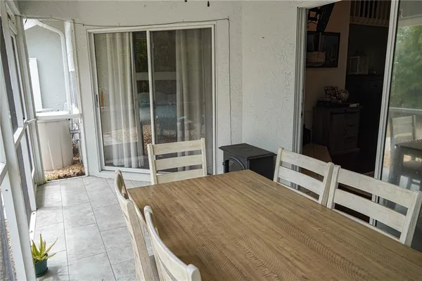 a view of a patio with table and chairs under an umbrella