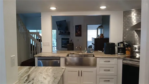 a kitchen with stainless steel appliances kitchen island granite countertop a sink and cabinets