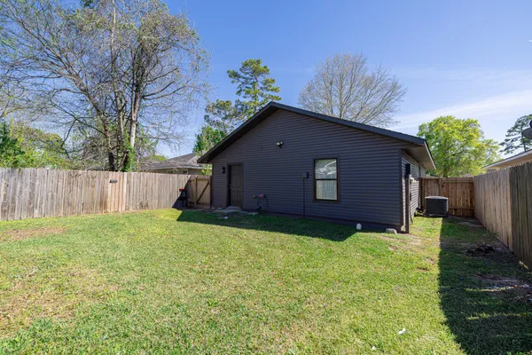 a view of a kitchen with a sink and a chandelier fan