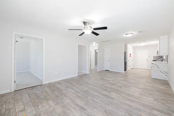wooden floor in an empty room with a window