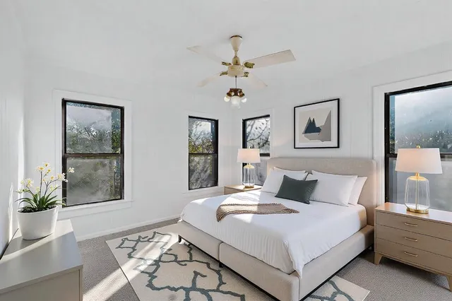 a bedroom with a bed and a window