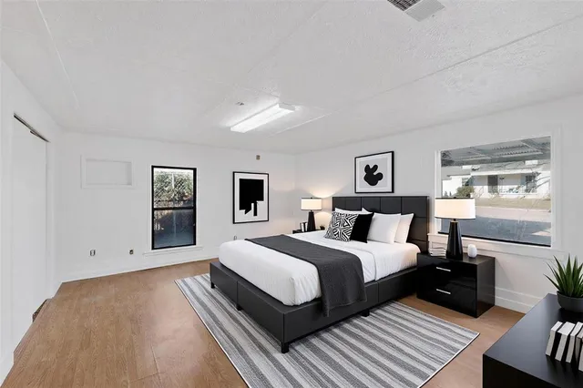 a bedroom with a bed and a night stand