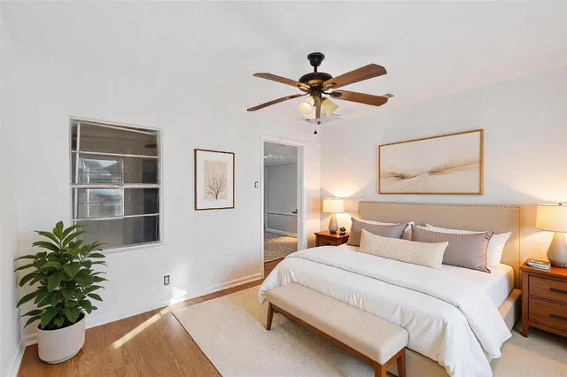 a bedroom with a bed and a potted plant