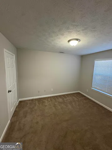 an empty room with a empty space and windows