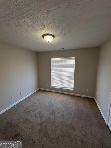 an empty room with a empty space and a window