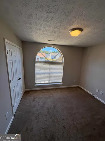 an empty room with a empty space and a window