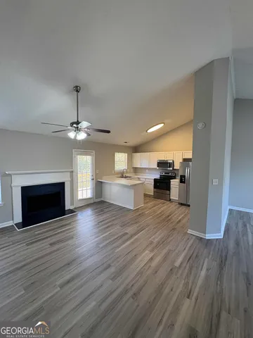 a view of a room with wooden floors and fireplace