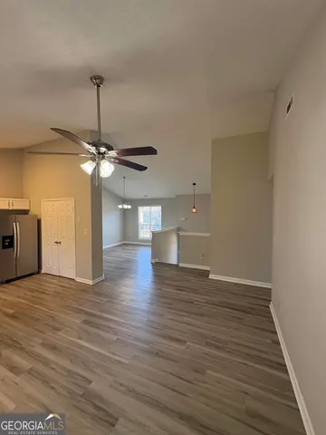 a view of a livingroom with a ceiling fan and wooden floor