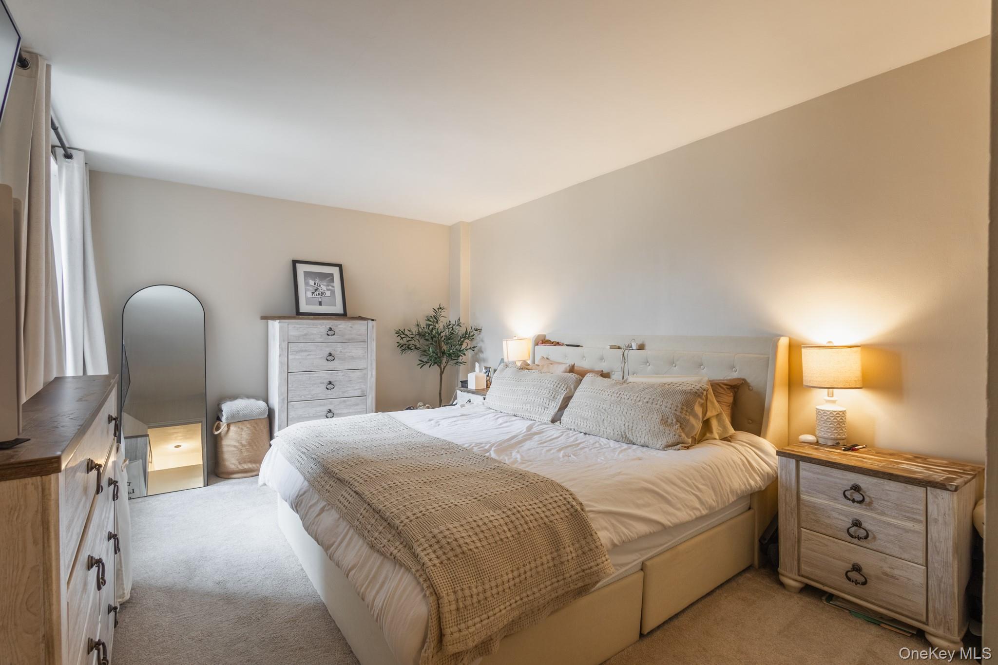 209-25 18th Avenue, Unit 3F Queens, NY 11360 - Photo 14 of 28 a bedroom with a bed and furniture