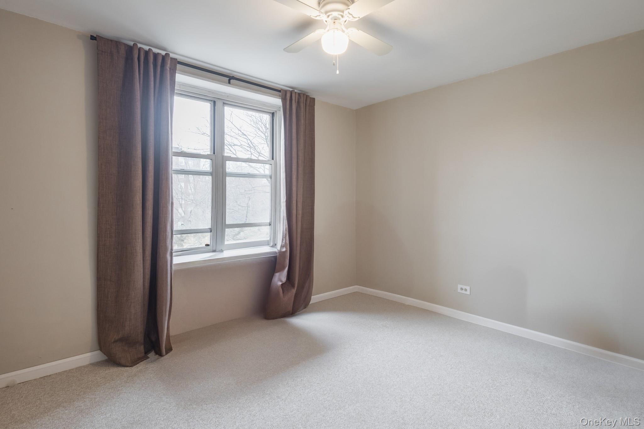 209-25 18th Avenue, Unit 3F Queens, NY 11360 - Photo 18 of 28 an empty room with windows and closet