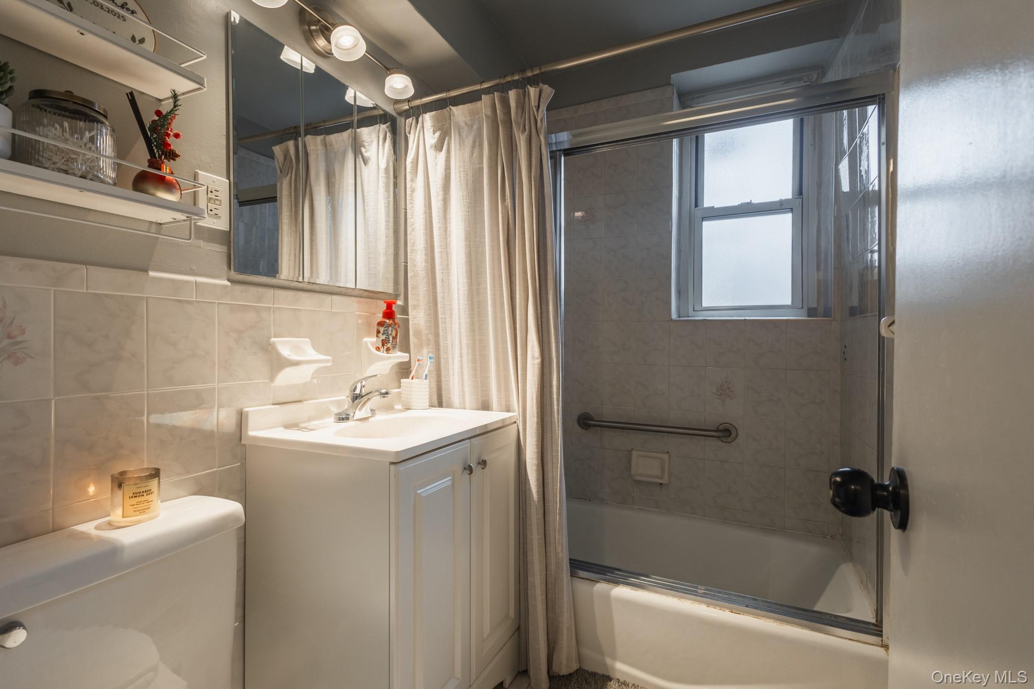 209-25 18th Avenue, Unit 3F Queens, NY 11360 - Photo 19 of 28 a bathroom with a sink toilet tub and shower