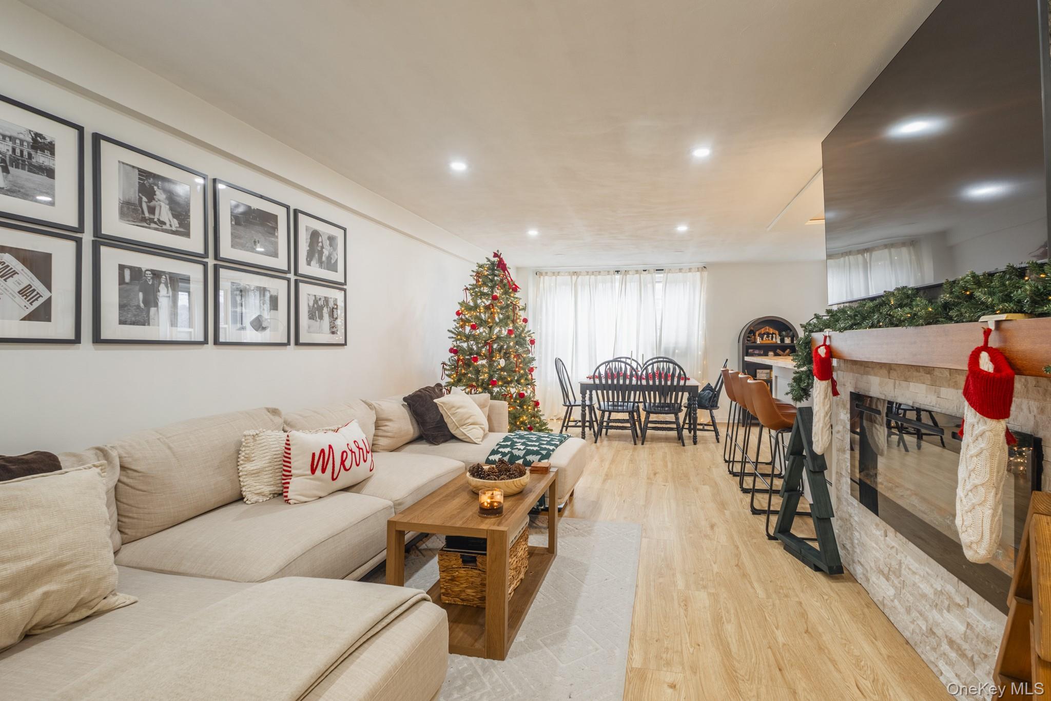 209-25 18th Avenue, Unit 3F Queens, NY 11360 - Photo 2 of 28 a living room with furniture and wooden floor