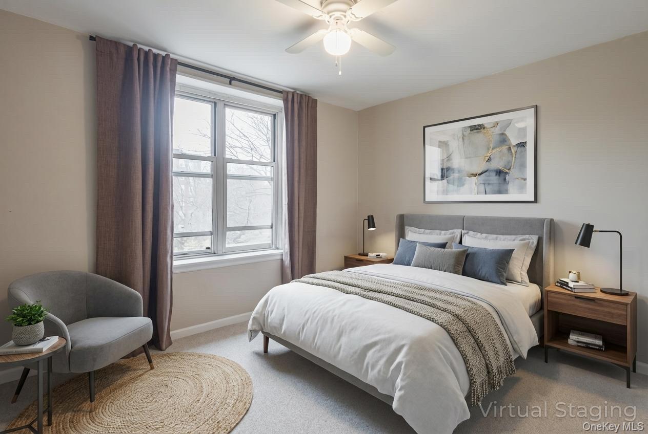 209-25 18th Avenue, Unit 3F Queens, NY 11360 - Photo 20 of 28 a bedroom with a bed and a couch