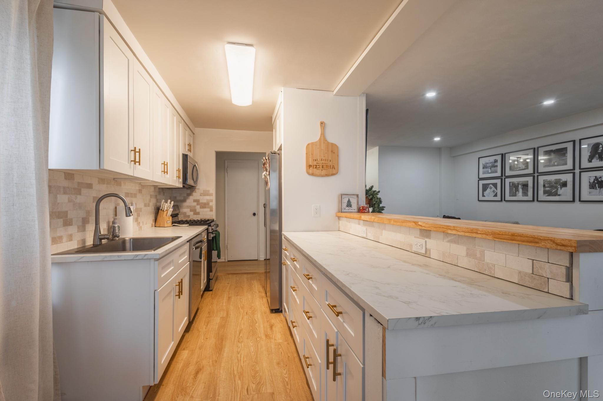 209-25 18th Avenue, Unit 3F Queens, NY 11360 - Photo 6 of 28 a spacious bathroom with a sink a mirror and vanity