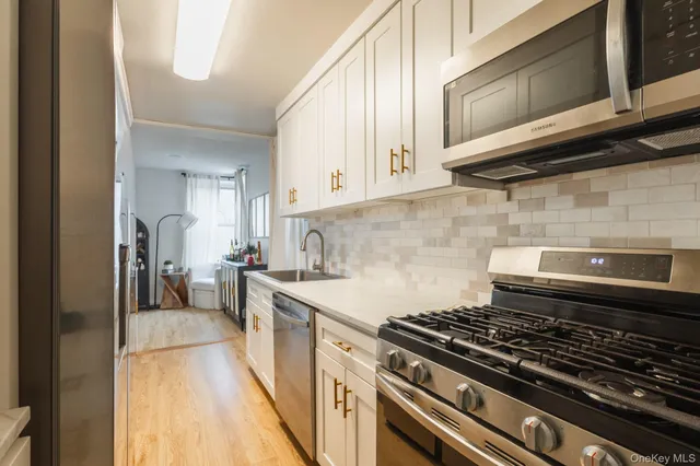 a kitchen with stainless steel appliances a stove a microwave and cabinets