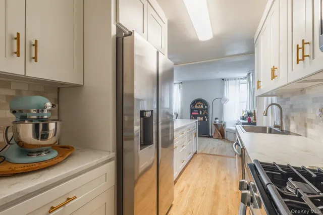 a view of a kitchen with a sink and cabinets