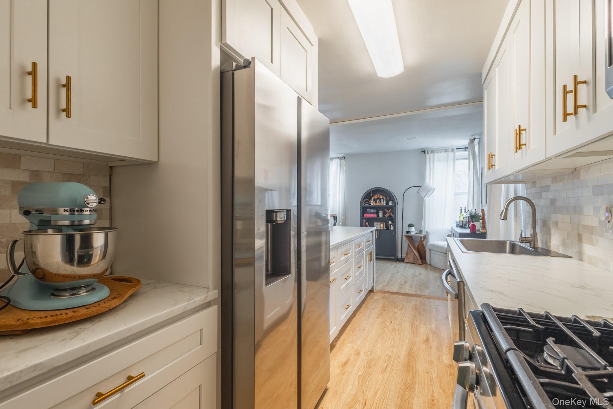 209-25 18th Avenue, Unit 3F Queens, NY 11360 - Photo 10 of 28 a view of a kitchen with a sink and cabinets