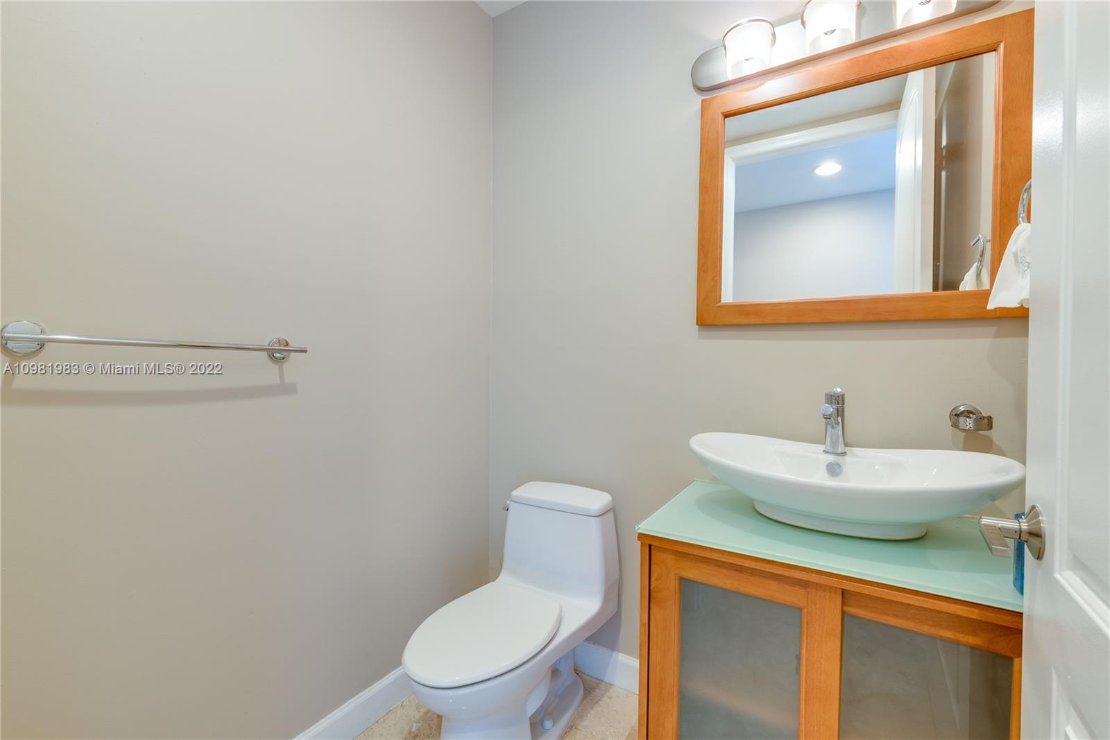 Spring Garden Miami, FL 33136 - Photo 16 of 39 a bathroom with a sink a toilet and mirror