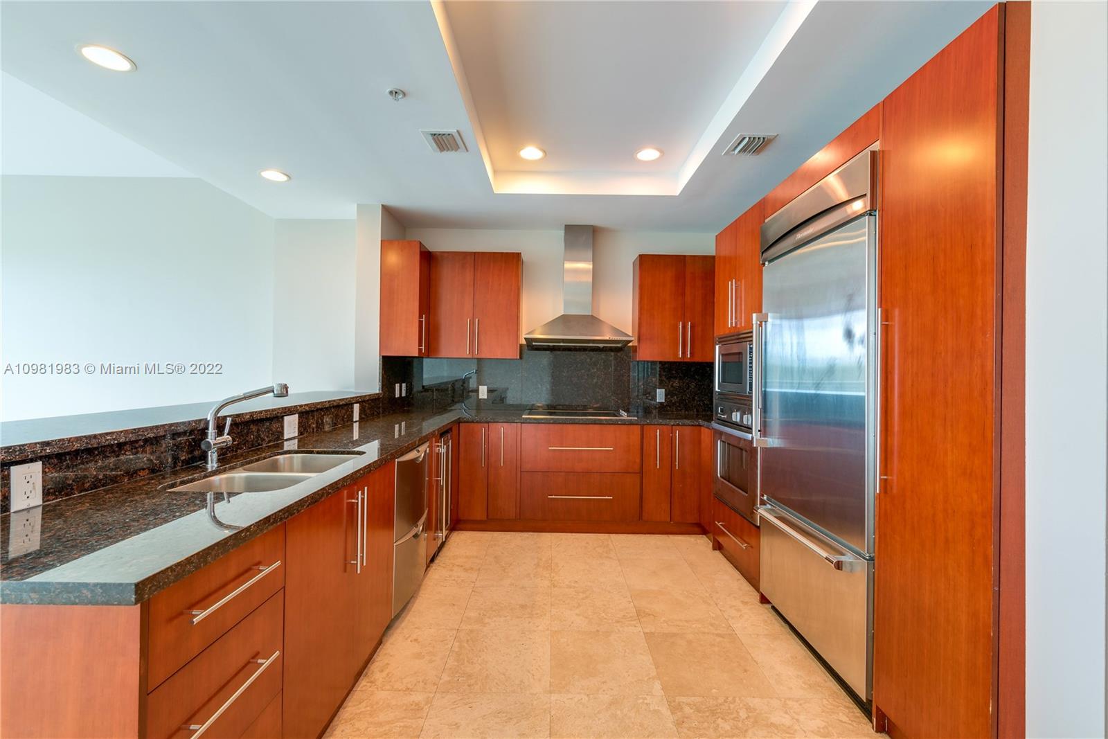 Spring Garden Miami, FL 33136 - Photo 7 of 39 a large kitchen with stainless steel appliances granite countertop a sink and cabinets