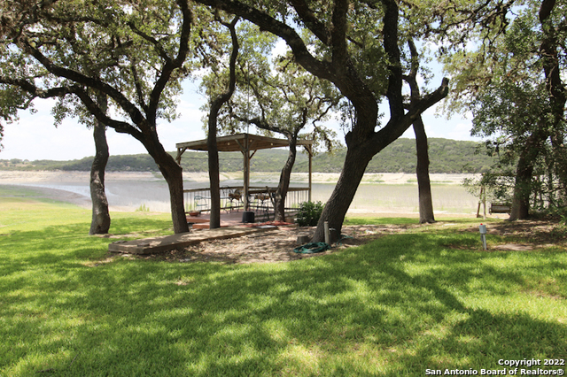 955 Faurie Road, Unit RV Lakehills, TX 78063 - Photo 4 of 8 a view of a yard with a tree