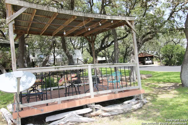 a view of a roof deck with a small yard