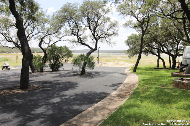 955 Faurie Road, Unit RV Lakehills, TX 78063 - Photo 7 of 8 a view of a yard with palm tree