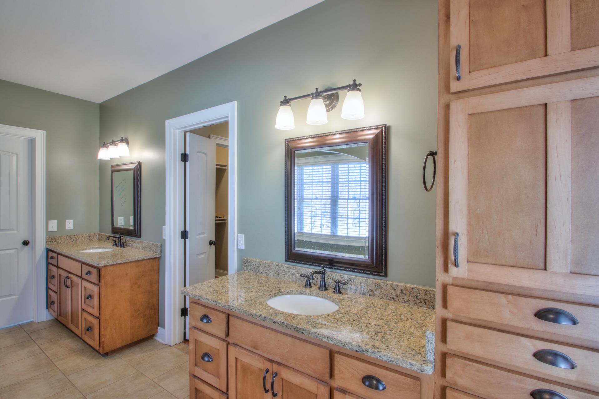 175 Holloway Road Lebanon, TN 37090 - Photo 13 of 30 a bathroom with a granite countertop sink and a mirror