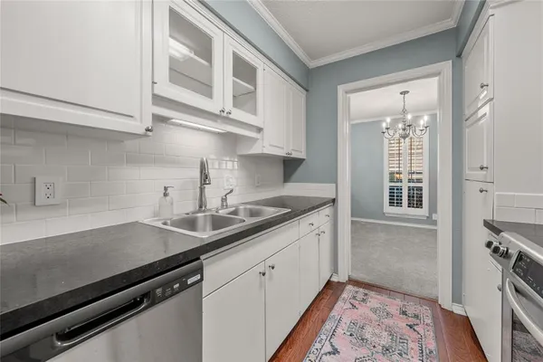 a kitchen with stainless steel appliances a sink stove and cabinets