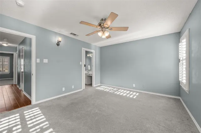 a view of a livingroom with a ceiling fan and window