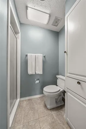 a bathroom with a toilet and a shower