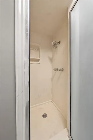 a bathroom with a glass shower door