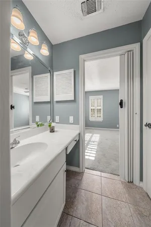 a bathroom with a sink a vanity and a mirror