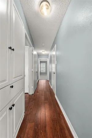 a view of hallway with wooden floor